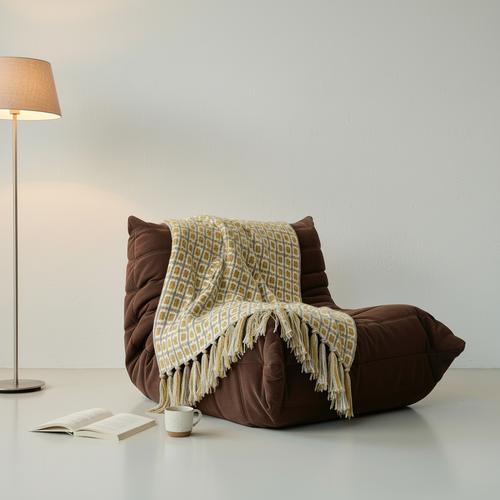 Knitted Tassel Throw Blanket draped over brown TOFU sofa chair